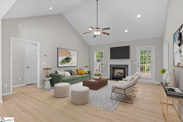 2575 Old Ansel School Rd, Greer, SC 29651 - living area featuring high vaulted ceiling, light wood-type flooring, a ceiling fan, baseboards, and a premium fireplace