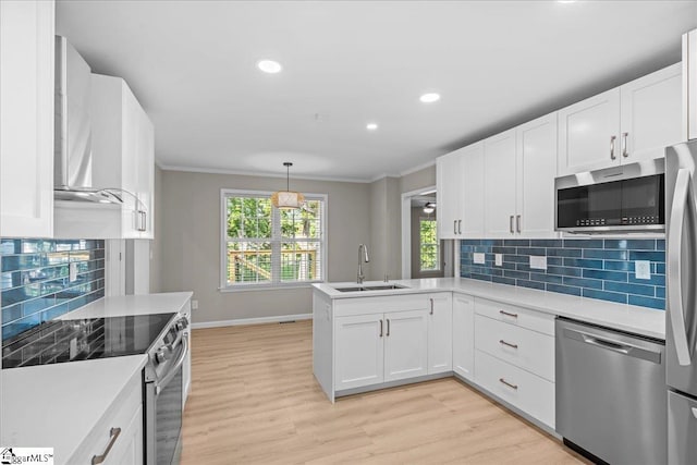 2575 Old Ansel School Rd, Greer, SC 29651 - kitchen featuring appliances with stainless steel finishes, ornamental molding, a sink, a peninsula, and white cabinetry