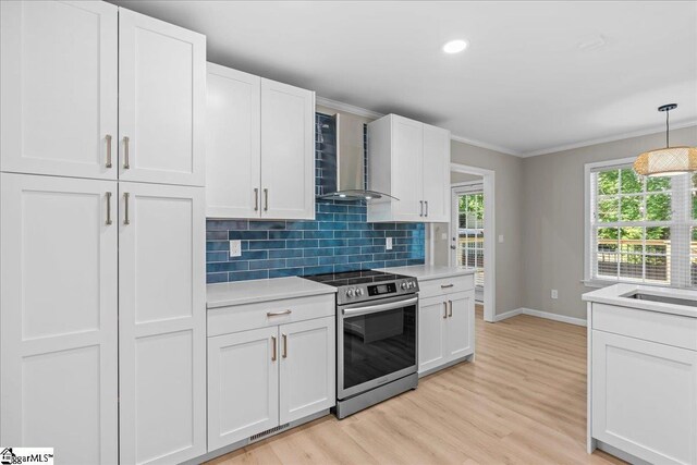 2575 Old Ansel School Rd, Greer, SC 29651 - kitchen featuring wall chimney exhaust hood, stainless steel electric range, baseboards, backsplash, and light countertops