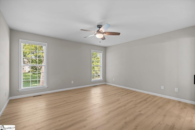 2575 Old Ansel School Rd, Greer, SC 29651 - spare room featuring plenty of natural light, a ceiling fan, baseboards, and light wood-style floors