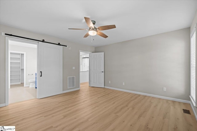 2575 Old Ansel School Rd, Greer, SC 29651 - unfurnished bedroom with light wood finished floors, a walk in closet, and baseboards