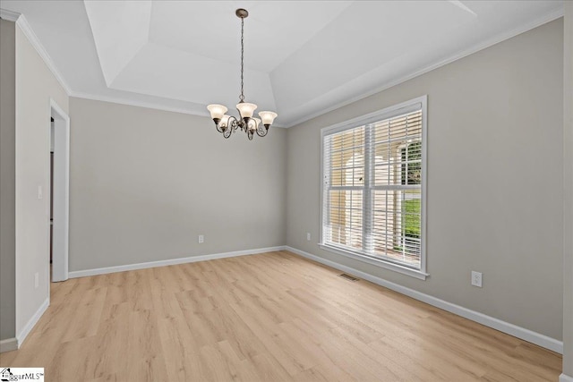2575 Old Ansel School Rd, Greer, SC 29651 - spare room featuring light wood-type flooring, a raised ceiling, ornamental molding, a chandelier, and baseboards