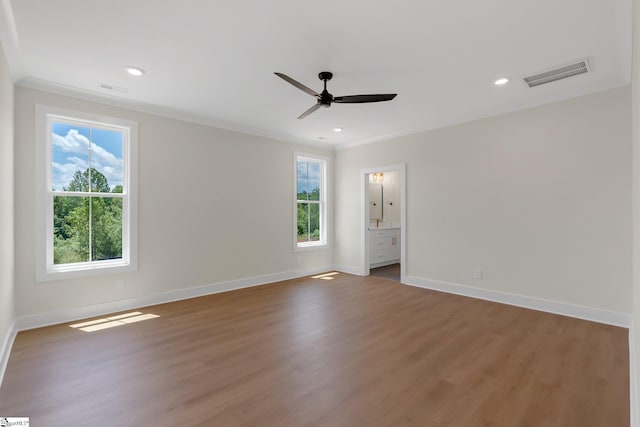 empty room featuring ceiling fan, ornamental molding, baseboards, wood finished floors, and recessed lighting