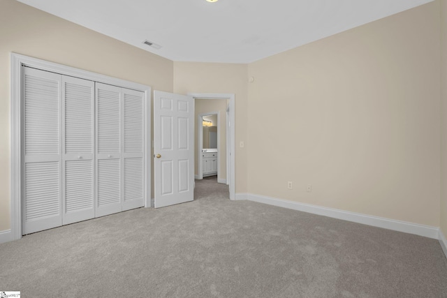 unfurnished bedroom featuring carpet flooring, baseboards, and a closet