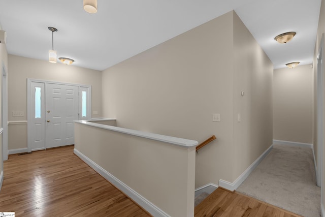 entryway featuring baseboards and wood finished floors