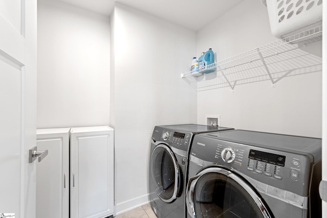 5 Timberwild Dr, Greenville, SC 29605 - clothes washing area with washing machine and clothes dryer, cabinet space, light tile patterned flooring, and baseboards