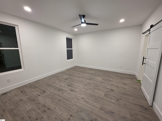 402 Edgewater Dr, Anderson, SC 29626 - spare room featuring a barn door, a ceiling fan, recessed lighting, baseboards, and wood finished floors