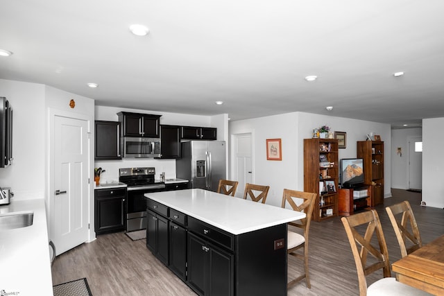 203 Bending Branch Rd, Greenville, SC 29605 - kitchen with appliances with stainless steel finishes, dark cabinetry, a breakfast bar area, a center island, and light countertops