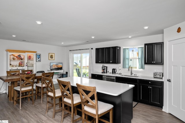203 Bending Branch Rd, Greenville, SC 29605 - kitchen with dark cabinets, dishwasher, a sink, light countertops, and recessed lighting