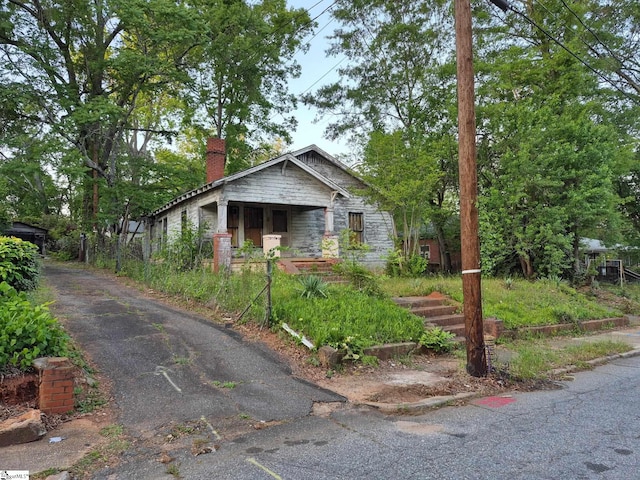 bungalow-style house featuring a chimney
