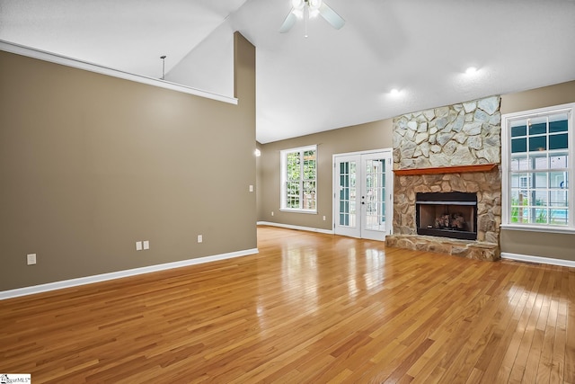 1298 Moorehead Pl, Pendleton, SC 29670 - unfurnished living room with light wood-type flooring, french doors, ceiling fan, baseboards, and high vaulted ceiling