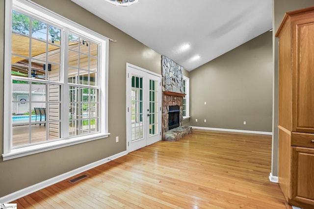 1298 Moorehead Pl, Pendleton, SC 29670 - unfurnished living room featuring hardwood / wood-style floors, baseboards, lofted ceiling, and a stone fireplace