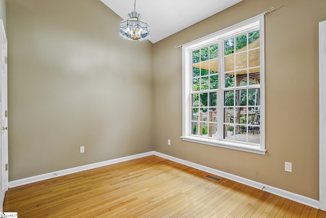 1298 Moorehead Pl, Pendleton, SC 29670 - unfurnished room featuring baseboards, a chandelier, hardwood / wood-style flooring, and vaulted ceiling