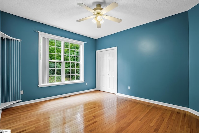 1298 Moorehead Pl, Pendleton, SC 29670 - spare room featuring hardwood / wood-style flooring, a textured ceiling, a ceiling fan, and baseboards
