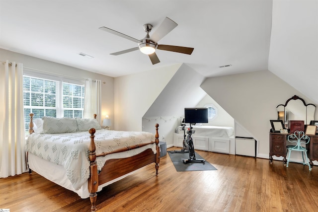 bedroom with wood finished floors, a ceiling fan, and lofted ceiling