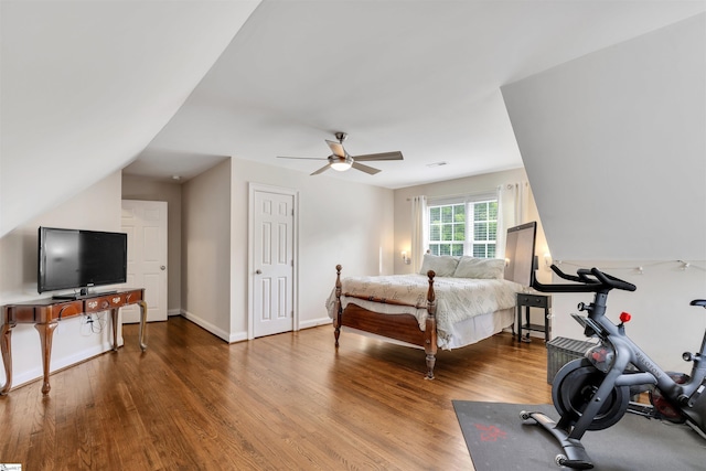 bedroom with wood finished floors, ceiling fan, and baseboards