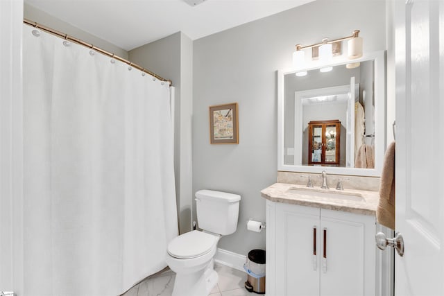 full bath featuring vanity, toilet, and baseboards