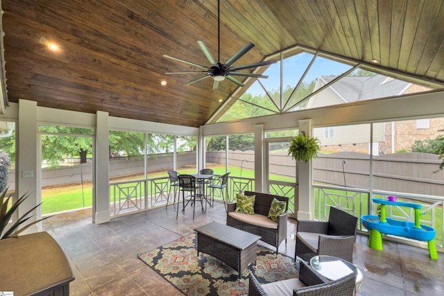 sunroom / solarium with ceiling fan, lofted ceiling, and an outdoor living space