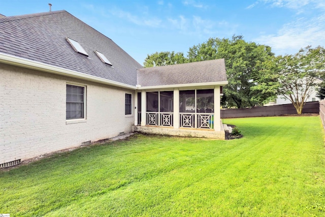 back of house with roof with shingles, a sunroom, crawl space, and brick siding