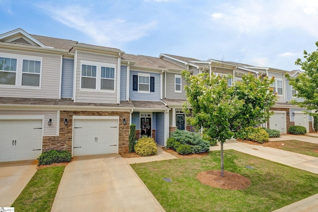 305 Yellow Fox Rd, Greer, SC 29650 - townhome / multi-family property featuring driveway, a garage, a front lawn, and stone siding