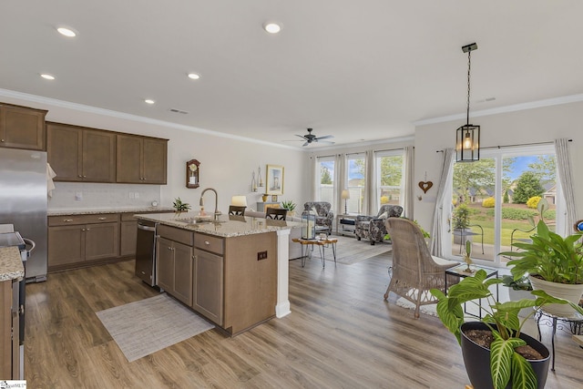 305 Yellow Fox Rd, Greer, SC 29650 - kitchen with appliances with stainless steel finishes, a sink, open floor plan, crown molding, and a ceiling fan