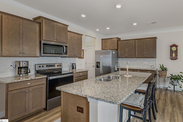 305 Yellow Fox Rd, Greer, SC 29650 - kitchen with stainless steel appliances, a sink, dark wood-type flooring, an island with sink, and tasteful backsplash