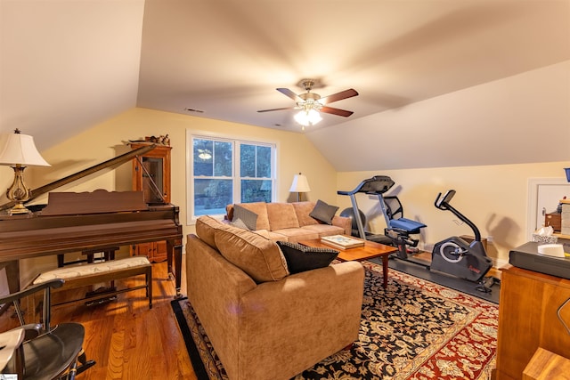 living room featuring lofted ceiling, wood finished floors, and ceiling fan