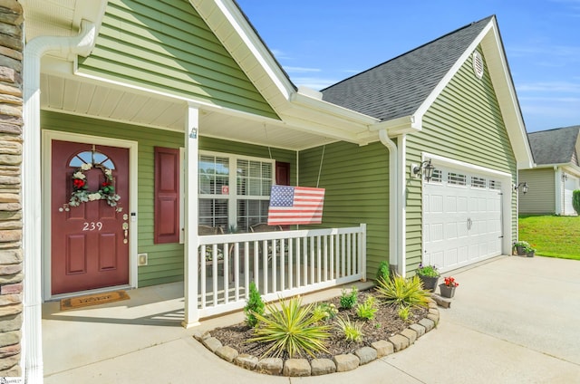 239 Walcott Dr, Lyman, SC 29365 - property entrance featuring a porch, roof with shingles, driveway, and a garage