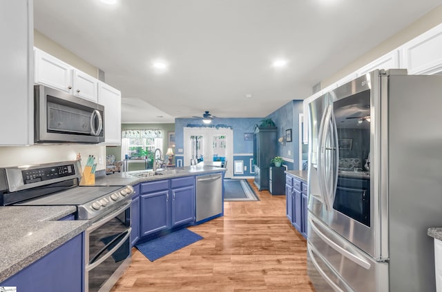 239 Walcott Dr, Lyman, SC 29365 - kitchen featuring stainless steel appliances, a ceiling fan, a sink, blue cabinets, and recessed lighting