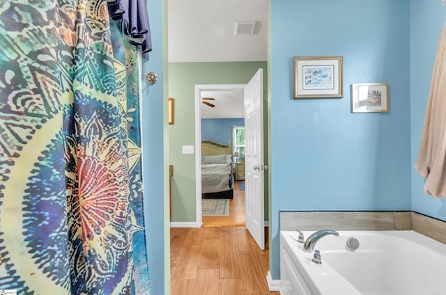 239 Walcott Dr, Lyman, SC 29365 - ensuite bathroom with a bath, wood finished floors, and baseboards