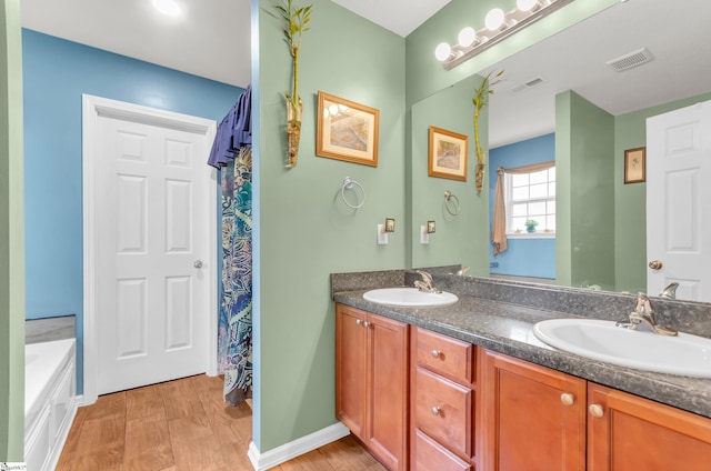 239 Walcott Dr, Lyman, SC 29365 - bathroom featuring double vanity, a tub, and baseboards