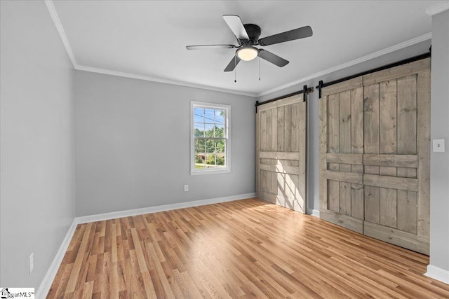 408 Bent Creek Dr, Greer, SC 29650 - unfurnished bedroom with ornamental molding, wood finished floors, baseboards, a barn door, and a ceiling fan