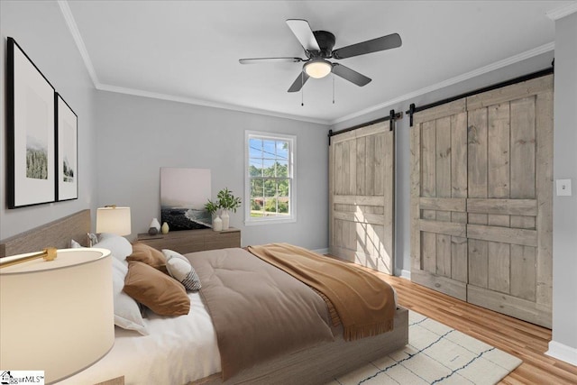 408 Bent Creek Dr, Greer, SC 29650 - bedroom with crown molding, wood finished floors, a barn door, and a ceiling fan