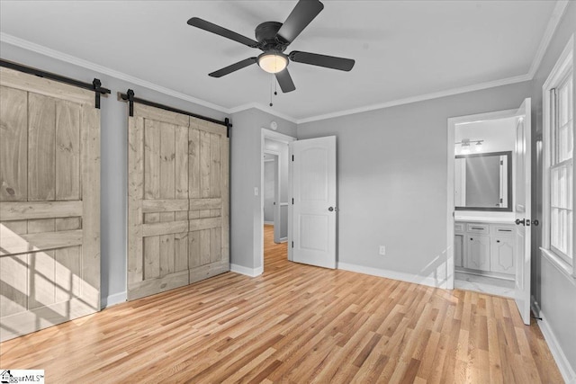 408 Bent Creek Dr, Greer, SC 29650 - unfurnished bedroom with light wood finished floors, baseboards, crown molding, connected bathroom, and a barn door