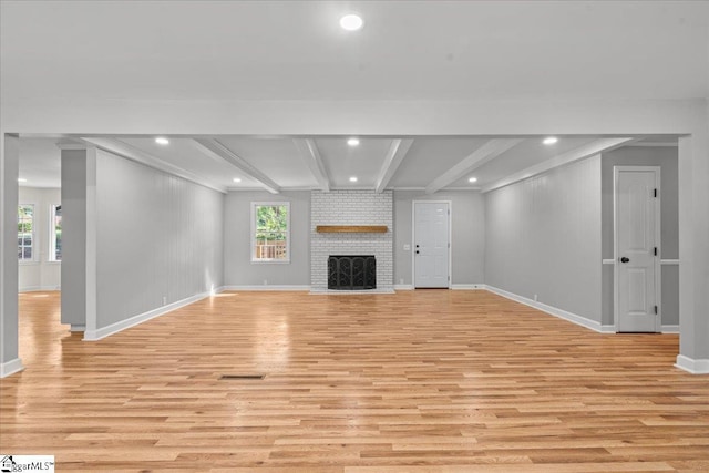 408 Bent Creek Dr, Greer, SC 29650 - unfurnished living room with light wood-style flooring, baseboards, plenty of natural light, beamed ceiling, and a brick fireplace
