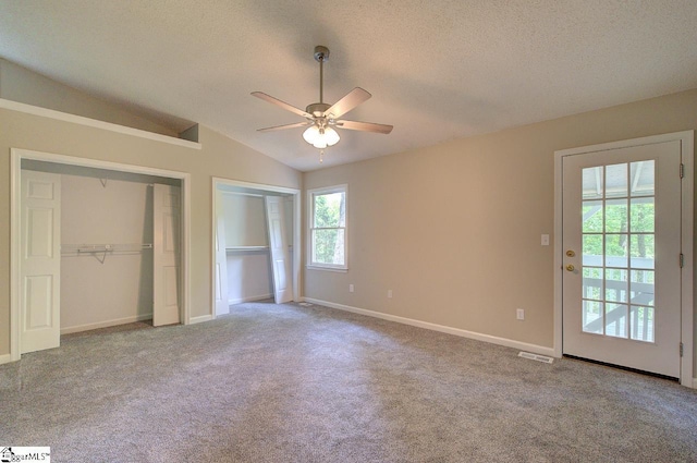 400 Halifax Dr, Greenville, SC 29615 - unfurnished bedroom featuring two closets, a textured ceiling, carpet floors, lofted ceiling, and baseboards