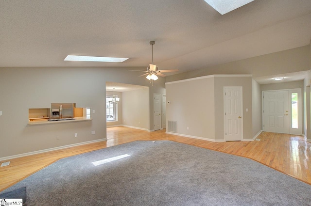400 Halifax Dr, Greenville, SC 29615 - unfurnished living room featuring a skylight, lofted ceiling, wood finished floors, baseboards, and a ceiling fan