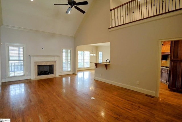 128 Palm Springs Way, Simpsonville, SC 29681 - unfurnished living room with high vaulted ceiling, healthy amount of natural light, a ceiling fan, baseboards, and a fireplace
