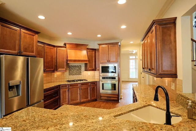 128 Palm Springs Way, Simpsonville, SC 29681 - kitchen with stainless steel appliances, a sink, crown molding, premium range hood, and wood finished floors