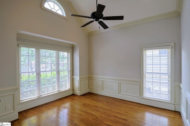 128 Palm Springs Way, Simpsonville, SC 29681 - spare room featuring plenty of natural light, ceiling fan, wood finished floors, crown molding, and a wainscoted wall