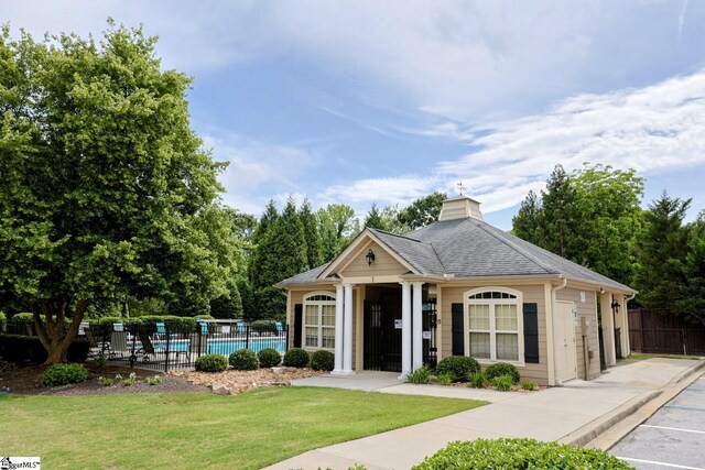 128 Palm Springs Way, Simpsonville, SC 29681 - view of front of property with a chimney, a community pool, and roof with shingles