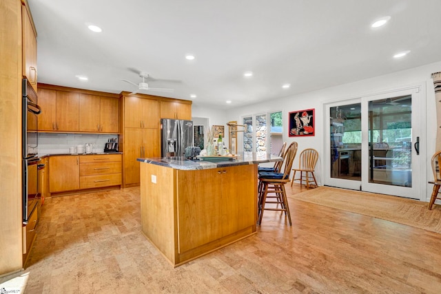 313 Viewmont Dr, Greenville, SC 29609 - kitchen with stainless steel fridge with ice dispenser, a center island, ceiling fan, recessed lighting, and tasteful backsplash