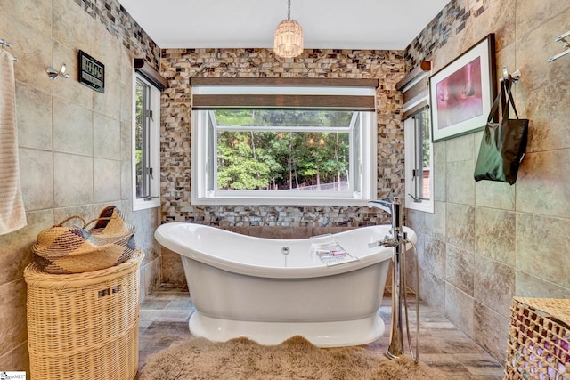 313 Viewmont Dr, Greenville, SC 29609 - bathroom featuring tile walls and a freestanding bath