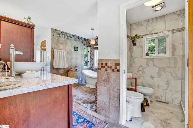 313 Viewmont Dr, Greenville, SC 29609 - full bath with tile walls, healthy amount of natural light, vanity, a freestanding bath, and a bidet