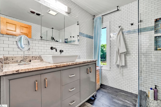 313 Viewmont Dr, Greenville, SC 29609 - bathroom featuring tile walls, vanity, and tiled shower