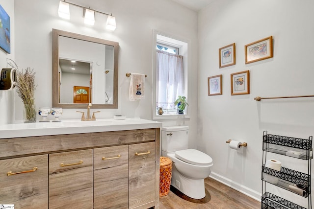 313 Viewmont Dr, Greenville, SC 29609 - bathroom with toilet, wood finished floors, vanity, and baseboards