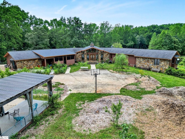 313 Viewmont Dr, Greenville, SC 29609 - rear view of property featuring stone siding, a forest view, and a patio area