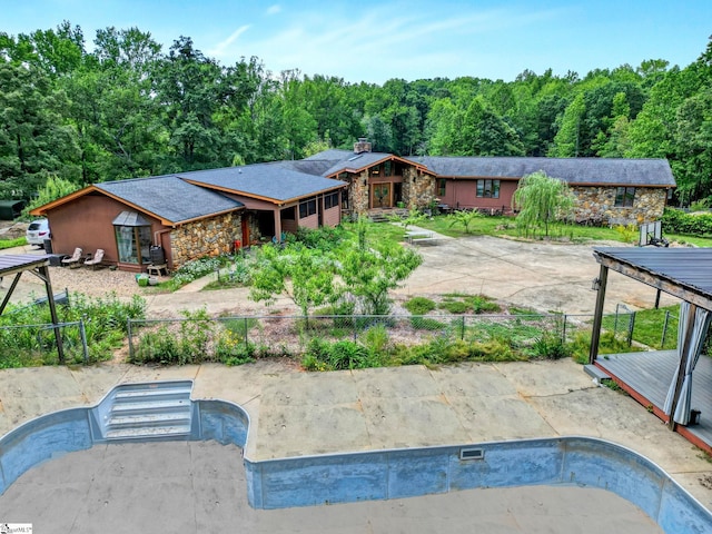 313 Viewmont Dr, Greenville, SC 29609 - view of swimming pool with fence, a wooded view, and an empty pool