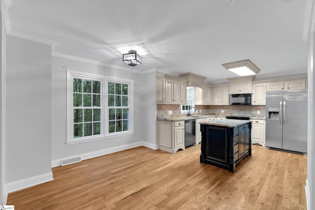 kitchen with black appliances, a sink, crown molding, baseboards, and backsplash