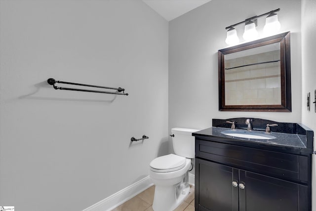 bathroom featuring baseboards, vanity, toilet, and tile patterned floors